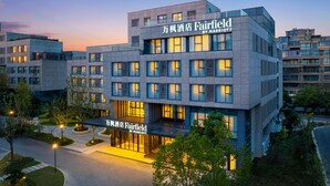 A multi-story hotel with a modern design, featuring a prominent sign for 'Fairfield by Marriott'.