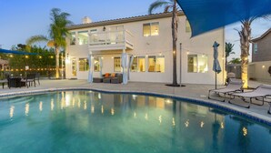 A two-story house with a swimming pool, outdoor seating, and string lights. - Resort-style Home with stunning views, pool, hot tub, putting green (Fallbrook)