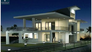 A modern two-story house with a balcony, large windows, and a driveway.