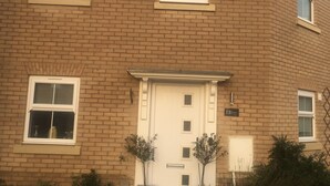 A two-story brick building with a white door and windows. - Impeccable 2-bed House in Attleborough (Attleborough)