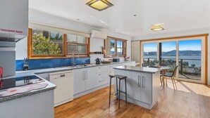 Una cocina moderna con una isla grande, un área de comedor con vistas y un balcón espacioso.