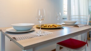 A dining table with a bowl, a wine glass, and a plate of food. - HAPPY HOUSE [7 minutes from MXP and 30 minutes from Milan] (Busto Arsizio)