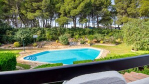 A swimming pool surrounded by lush greenery and trees. - TREBOL: Apartment in l'Escala with community pool and garden, ideal for families (L'Escala)