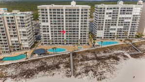 A high-rise hotel with multiple balconies, a pool area, and a beach view. - ⭐Newly Remodeled Beach FrontCondo-Great Views from Balcony-Windward Pointe 603⭐ (Orange Beach)