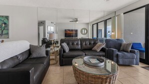 A modern living room with a sofa, a coffee table, and a TV. - ⭐Newly Remodeled Beach FrontCondo-Great Views from Balcony-Windward Pointe 603⭐ (Orange Beach)
