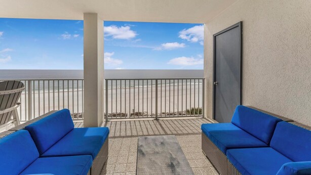 A balcony with two blue sofas, a metal railing, and a view of the beach. - ⭐Newly Remodeled Beach FrontCondo-Great Views from Balcony-Windward Pointe 603⭐ (Orange Beach)