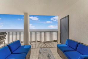 A balcony with two blue sofas, a metal railing, and a view of the beach. - ⭐Newly Remodeled Beach FrontCondo-Great Views from Balcony-Windward Pointe 603⭐ (Orange Beach)