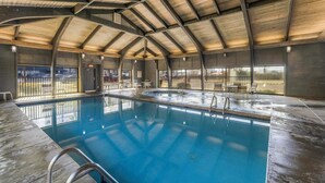 An indoor swimming pool with a high ceiling and large windows. - ⭐Newly Remodeled Beach FrontCondo-Great Views from Balcony-Windward Pointe 603⭐ (Orange Beach)