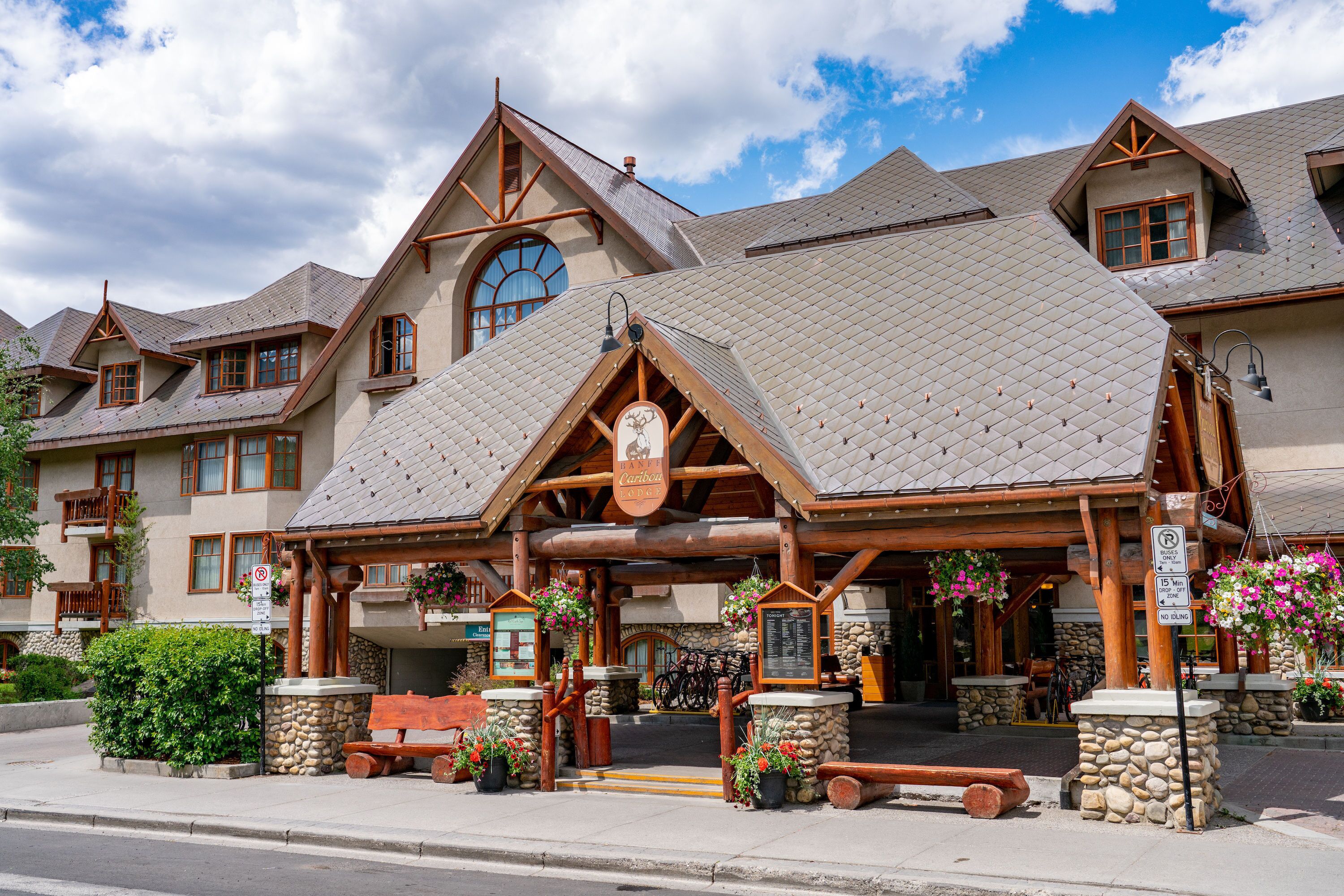 A large building with a stone facade, wooden beams, and a sloped roof.