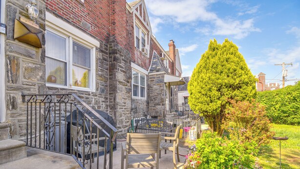 A stone building with a staircase, outdoor seating, and a garden. - Quaint Lansdowne Getaway Near Downtown Philly! (Lansdowne)