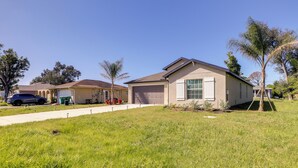 A residential area with houses, a driveway, and a lawn. - Airy Port Charlotte Home w/ Smart TV Near Beaches! (Port Charlotte)