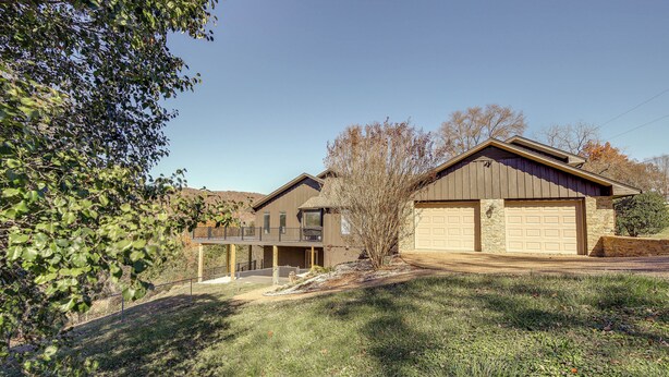 A two-story house with a garage, a covered porch, and a landscaped yard. - Lafollette Home: Community Pool & Mountain Views! (La Follette)