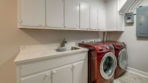 A laundry room with a washing machine, a sink, and white cabinets. - Lafollette Home: Community Pool & Mountain Views! (La Follette)