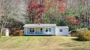 A single-story house with a front porch, a chimney, and a satellite dish. - Pet-friendly Topton Home w/ Patio, Deck & Views! (Topton)