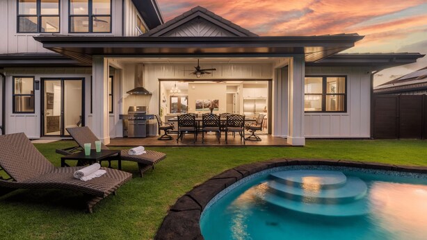 A modern house with a covered patio, outdoor seating, and a swimming pool. - Hale Ho'okipa: 2 Homes/2 Pools in Poipu-Sleeps 16 (Koloa)