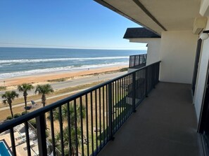 A balcony with a view of the beach and ocean. - TOP FLOOR Spectacular Ocean and Pool View Condo  (Ormond Beach)