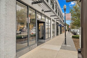 Located in Hyde Park Village, this building offers a clean and minimalist exterior with a combination of white brick and glass.