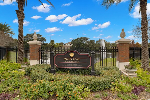 Escape to a serene oasis at Swann Pond, surrounded by lush greenery and beautiful plants.