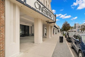 Welcome to Cinebistro, a modern building with a clean design and easy access to the entrance via a wide walkway.