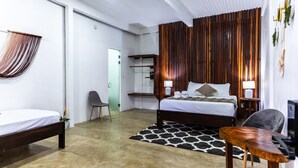 A modern bedroom with a large bed, a desk, and a chair. There is a wooden panel wall and a ceiling with recessed lighting. - El Deseo Serendipity Hotel (Colorado)
