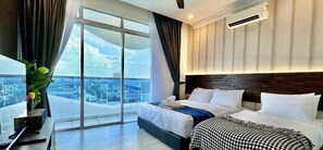 A hotel room with a large bed, a desk, and a view of the city through floor-to-ceiling windows. - The Wave Residence (Malacca City)