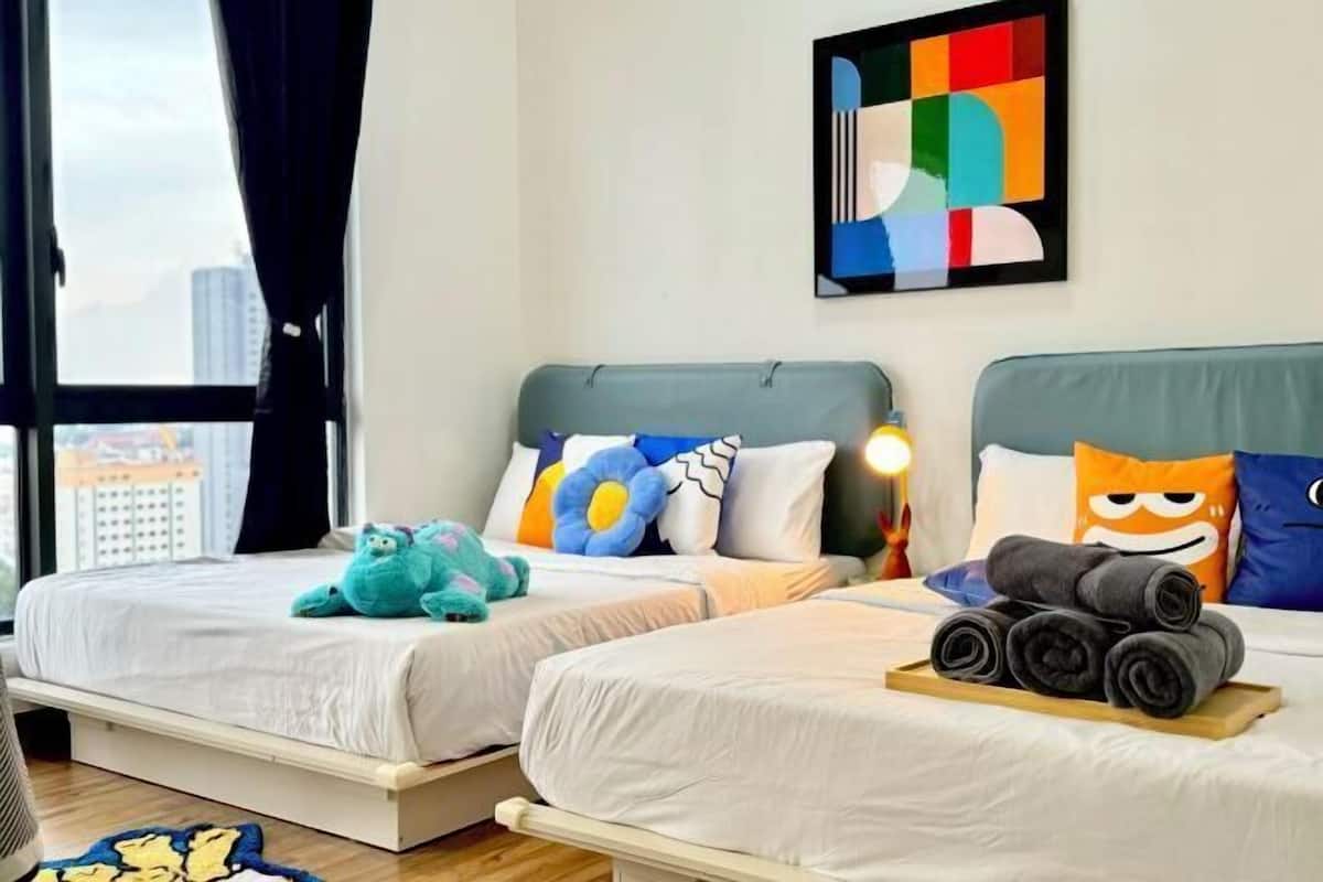A hotel room with two beds, a city view, a colorful abstract painting, and a window with curtains.