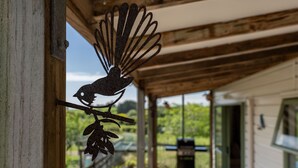 A rustic wooden structure with a metal bird sculpture on a branch. - Fantail Cottage - 35mins to Raglan &15 mins to shopping centre.
Farm outlook (Whatawhata)