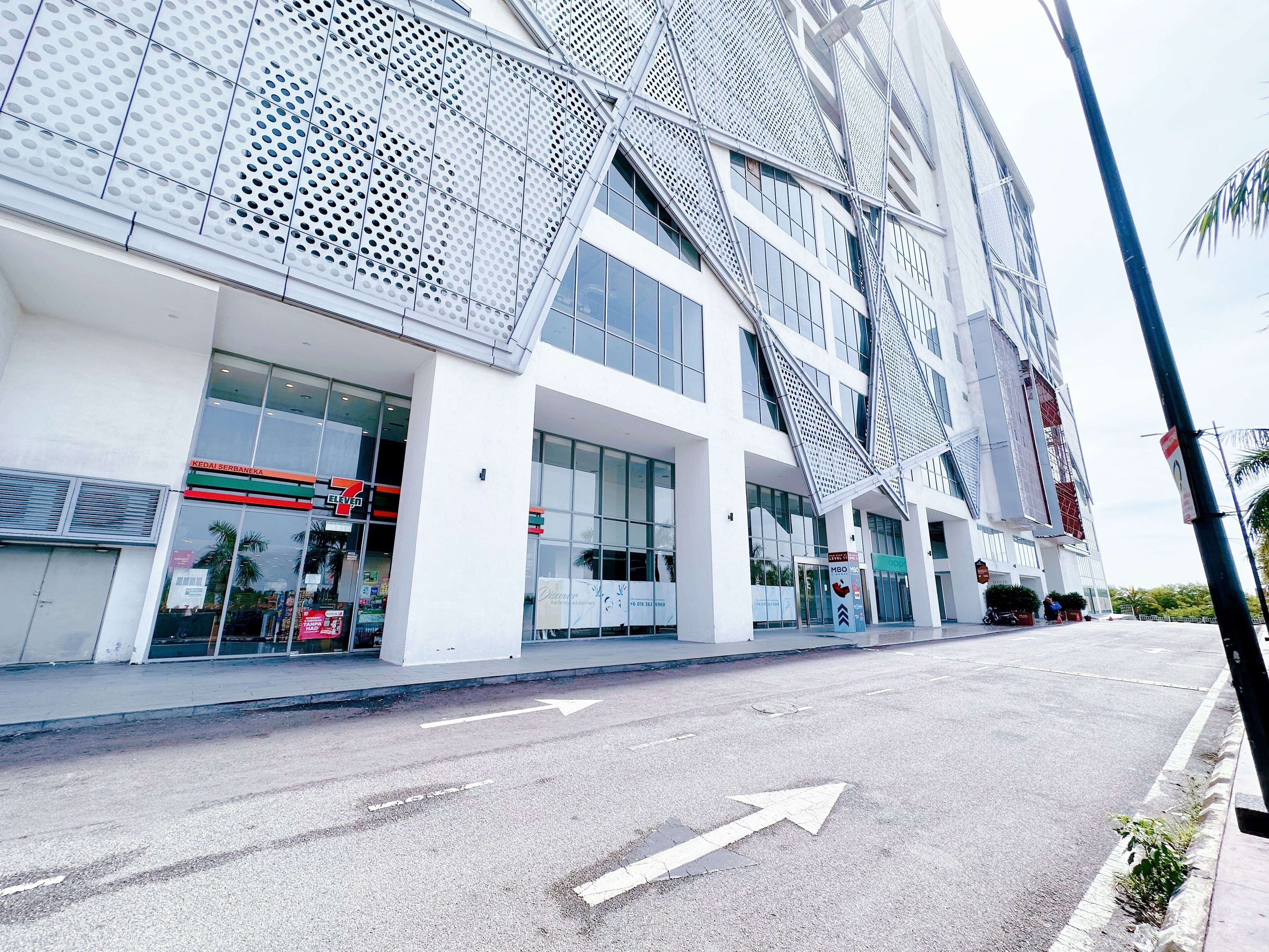 A modern building with large windows and a distinctive metal facade.