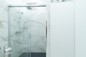 Shower, hair dryer, towels, toilet paper