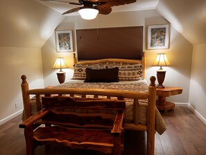 A bedroom with a wooden bed, two bedside lamps, a ceiling fan, and two framed pictures on the walls. - Beauty in the pines!
Flagstaff Az (Flagstaff)