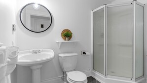 A bathroom with a pedestal sink, toilet, and a glass-enclosed shower. - Studio 5~ Cozy BDRM w/ Private Bath (Moncton)