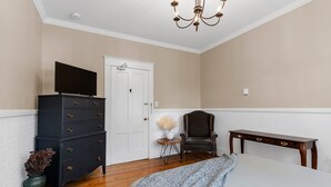 A bedroom with a bed, dresser, chair, and a small table. - Studio 5~ Cozy BDRM w/ Private Bath (Moncton)