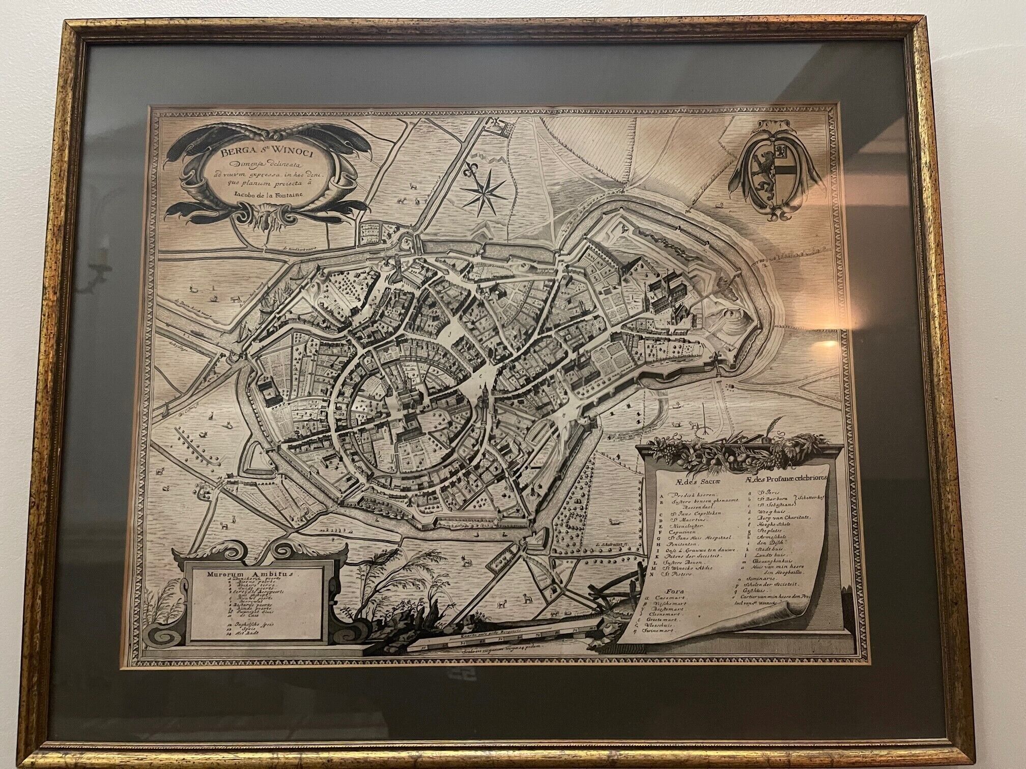A framed historical map with detailed street layouts and landmarks.