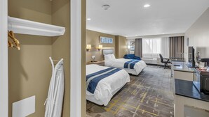 A hotel room with two beds, a desk, a chair, a TV, and a window with curtains. - Baymont by Wyndham Kansas City North (North Kansas City)