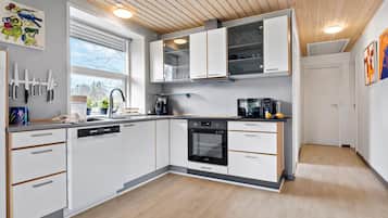 Fridge, stovetop, dishwasher, coffee/tea maker