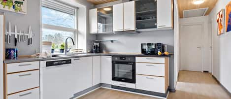 Fridge, stovetop, dishwasher, coffee/tea maker