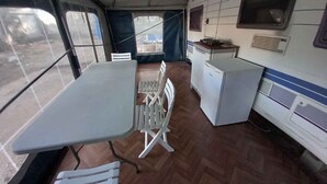 A compact kitchen with a refrigerator, a microwave, and a sink. - Mobilehome Caravan by the sea 6 (Ugljan)