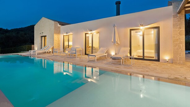 A modern poolside area with lounge chairs and a clear pool. - Indulge in Opulence at Lithari Enac—Luxury Villa with Private Pool (Kavvadades)