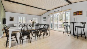 A spacious dining area with a high ceiling, large windows, and a view of the outdoors. - 3 bedroom amazing home in Vejby (Vejby)