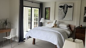 A bedroom with a bed, a desk, a chair, a lamp, and a painting. - Sweeping Views, Private Deck,  Outdoor Spa #2 (Nicasio)