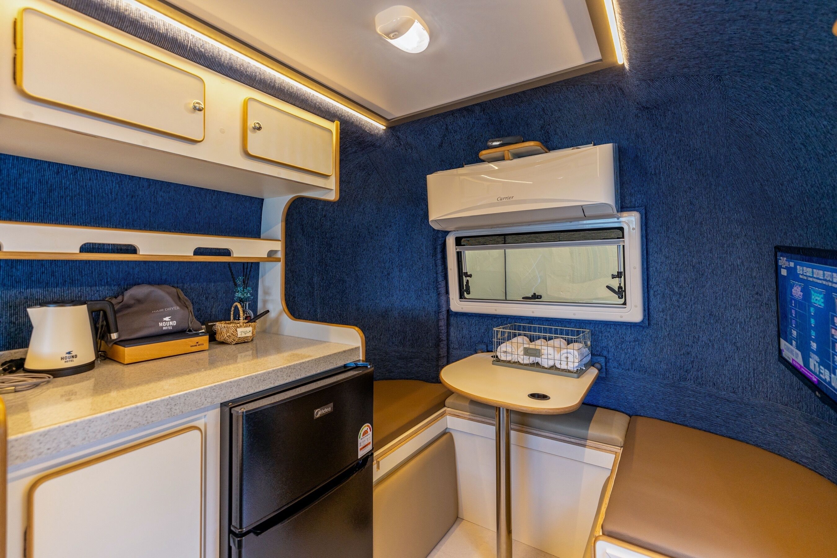 A compact kitchenette with a refrigerator, stove, and sink.