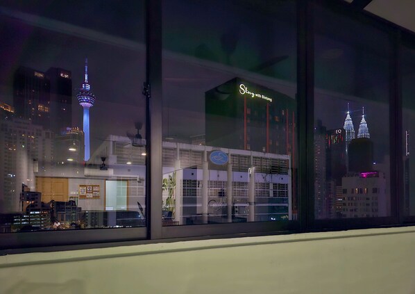 A view of a building with a sign reading "Story with Bintang" and a reflection of the Petronas Towers.