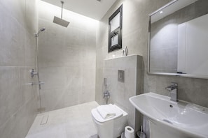 A modern bathroom with a shower, toilet, and sink. - Mabaat - Al Malqa - 538 (Riyadh)