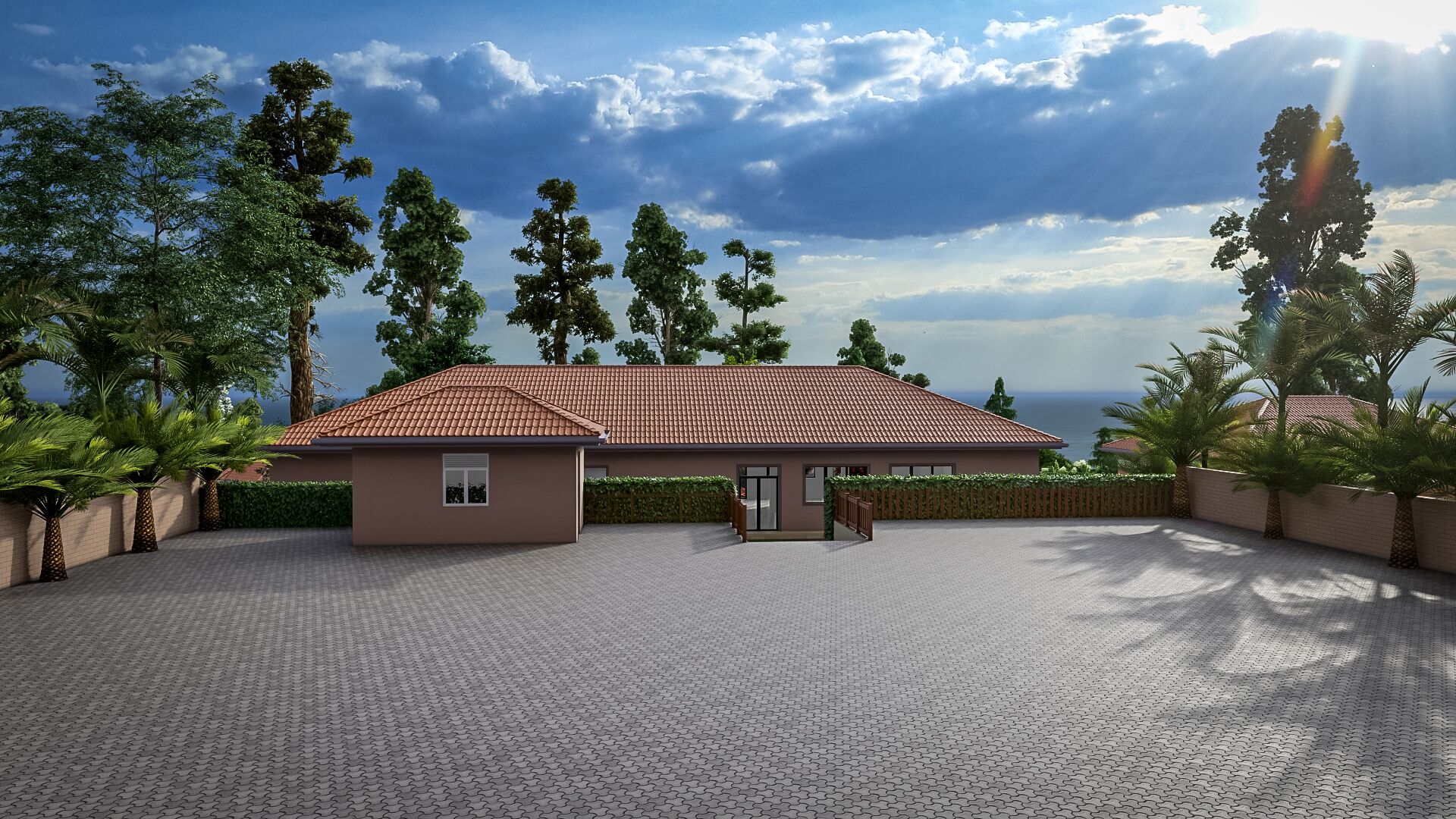 A building with a tiled roof, surrounded by trees and a paved area.