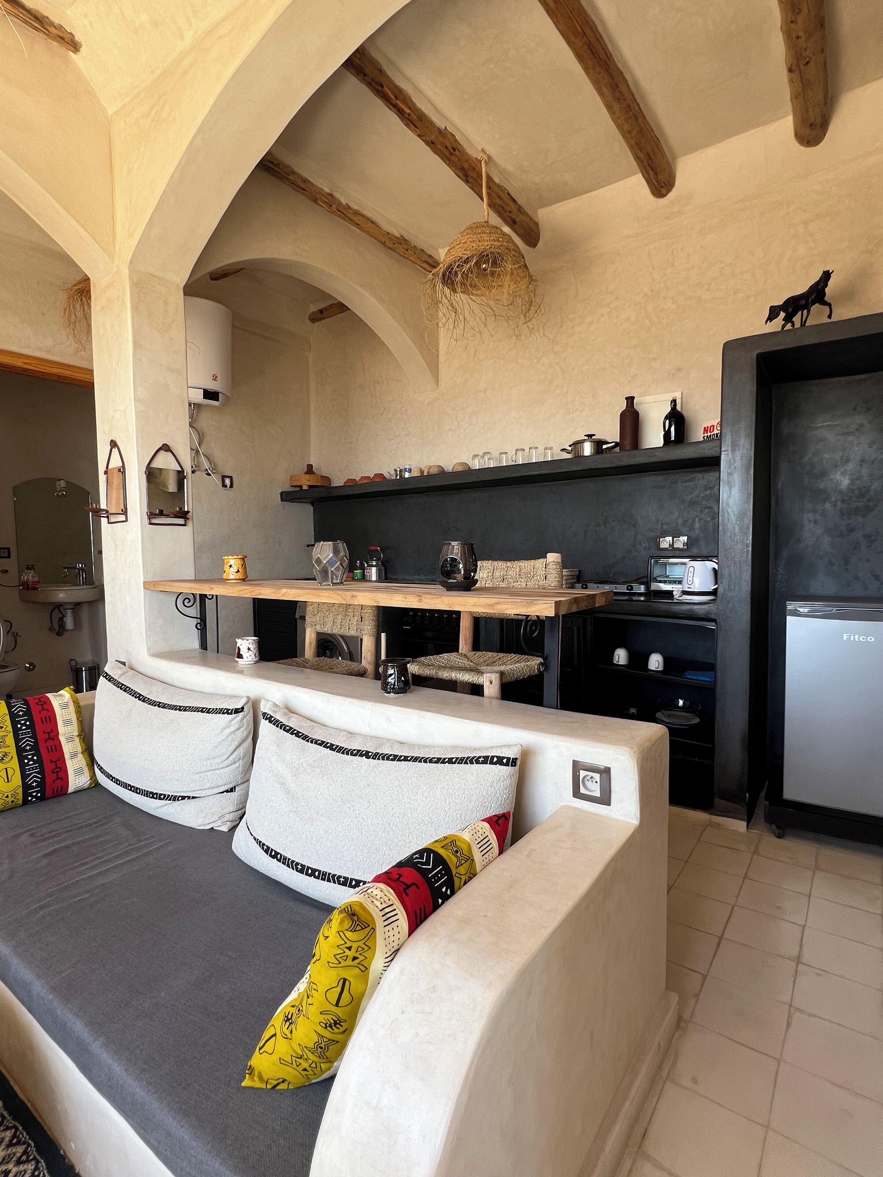 A modern kitchen with a built-in oven, a toaster, and a refrigerator.