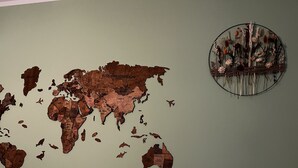 A world map with a circular decorative piece on the wall. - One bedroom flat in the center of Riga (Riga)