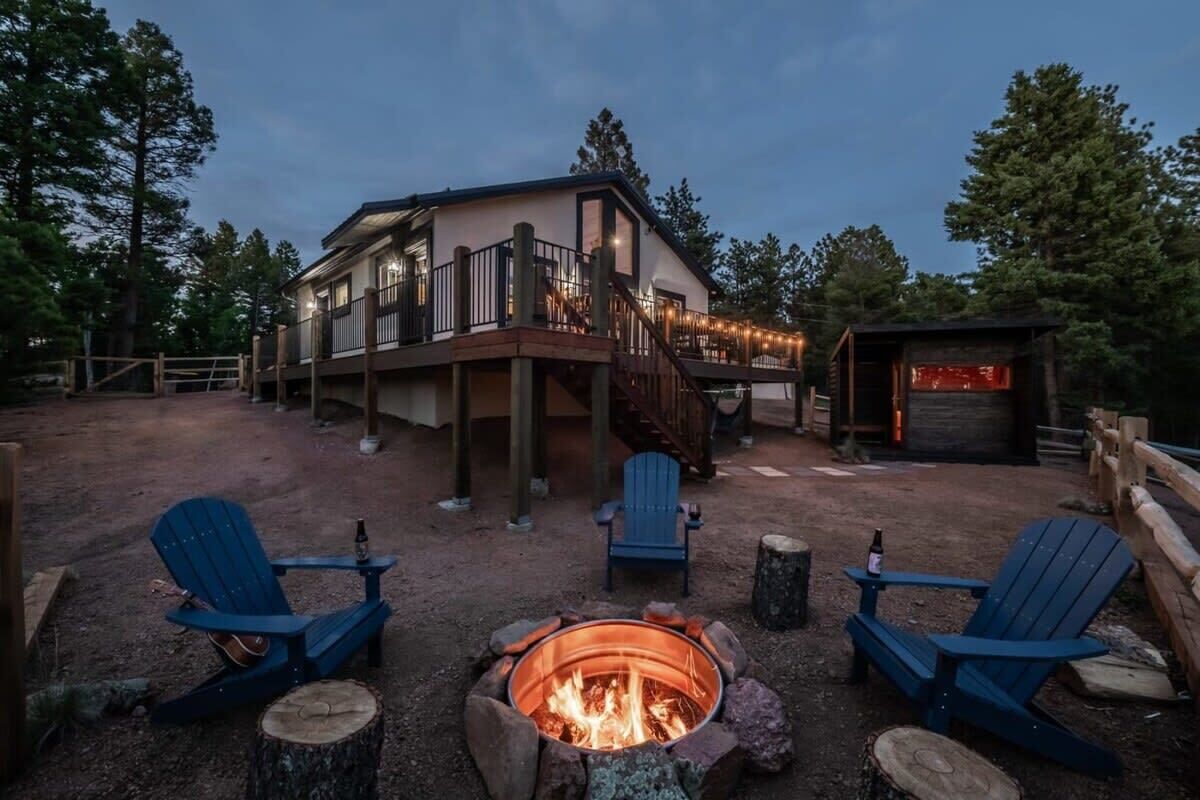 A lodge with a fire pit, outdoor seating, and a deck.