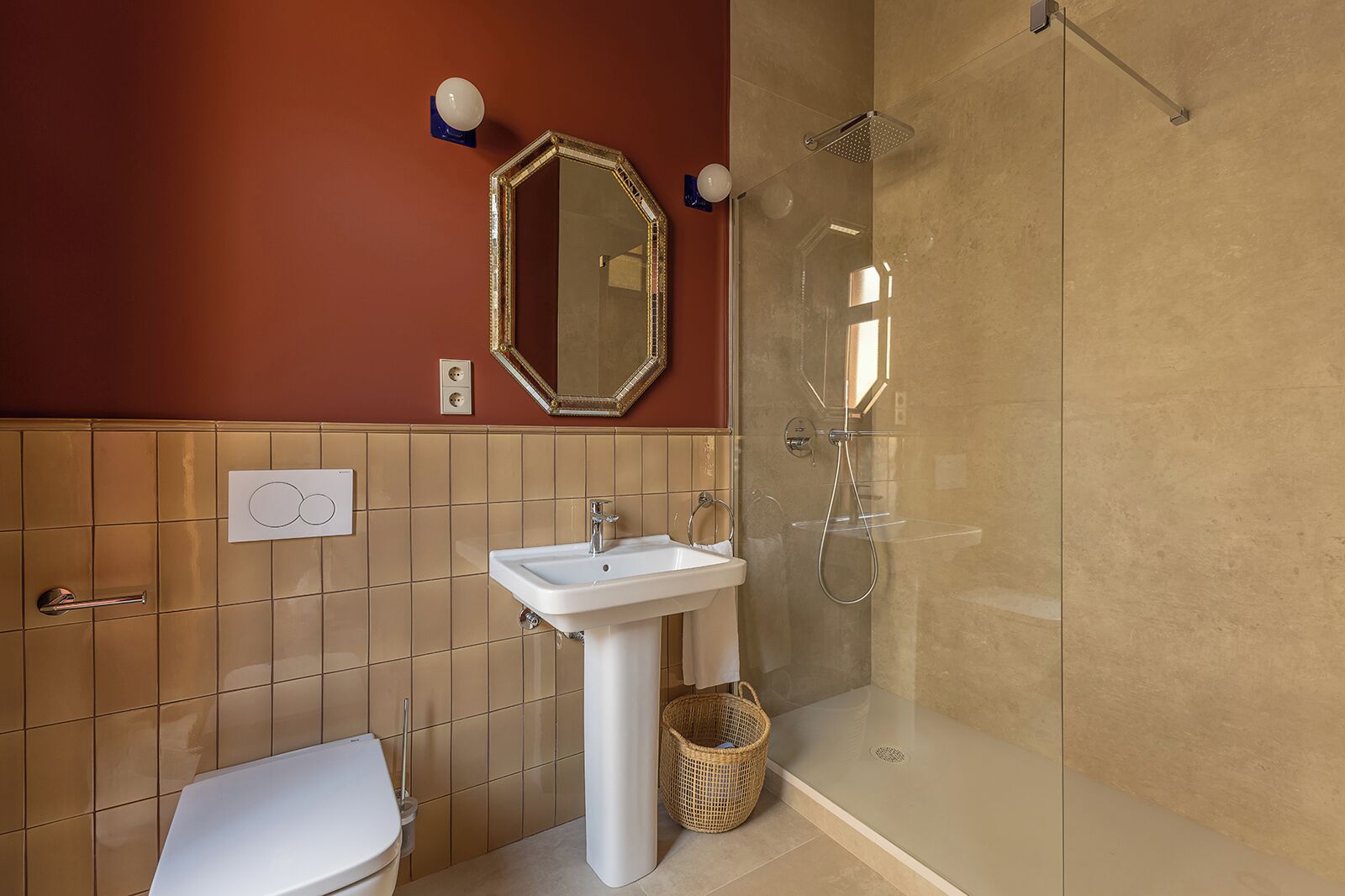 A bathroom with a white sink, a mirror, a shower, and a toilet.