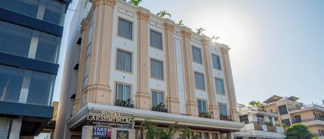 A hotel with a classic facade, multiple floors, and a prominent entrance with signage for a restaurant and banquet hall.