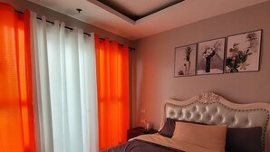 A hotel room with a large bed, a headboard with a tufted design, and three framed pictures on the wall. - Birch Tower Manila (Manila)